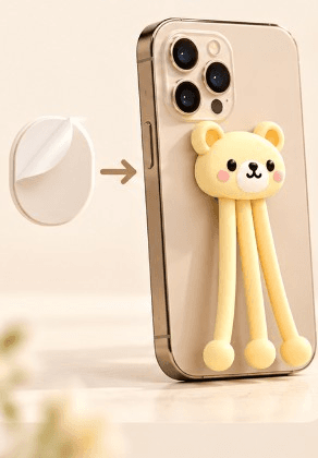 Adhesive pad sticking Bendi Bear onto the back of a phone